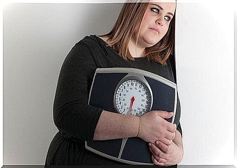 Depressed woman with scales in her arms