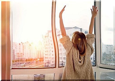 Woman stretches in front of a window and waits for changes