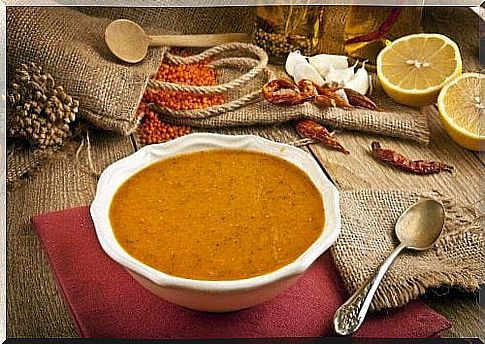 There is a plate of lentil soup on a table.