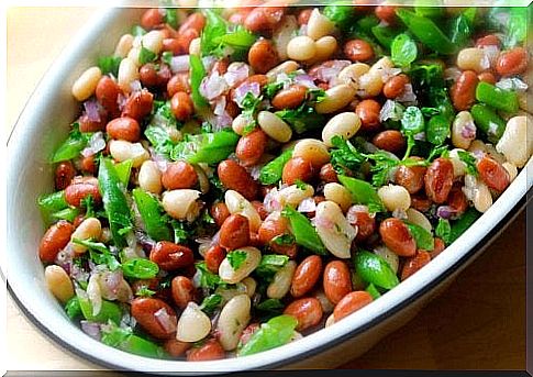 A bowl filled with red lentil salad.