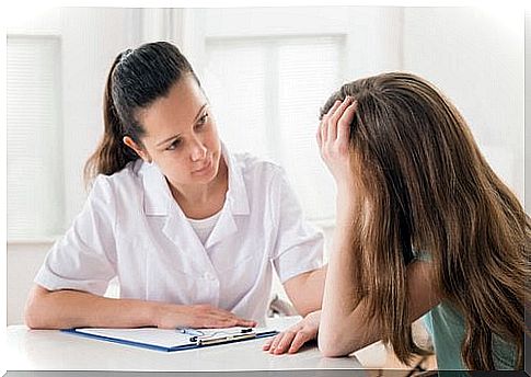 Woman having a panic attack with a doctor